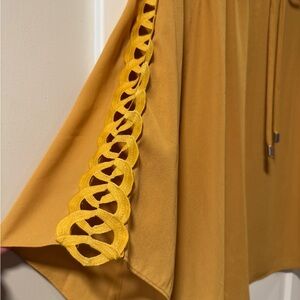 Beautiful women’s golden flowy top, with gorgeous sleeve detail!